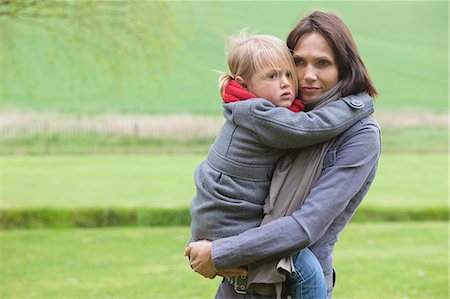 Woman carrying her daughter Stock Photo - Premium Royalty-Free, Code: 6108-06168465