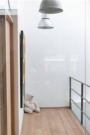 Teddy bear in the corner of a house Stock Photo - Premium Royalty-Free, Code: 6108-06168477