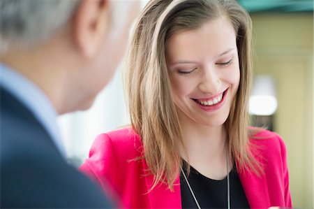 Business executives discussing in an office corridor Stock Photo - Premium Royalty-Free, Code: 6108-06168492