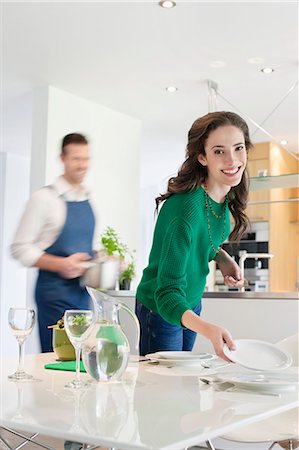 dining 30s two people - Couple preparing to serve dinner Stock Photo - Premium Royalty-Free, Code: 6108-06168415