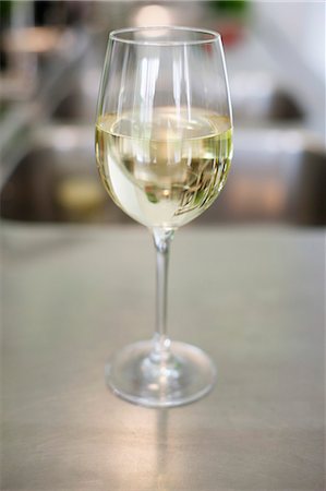 White wine in a wineglass Stock Photo - Premium Royalty-Free, Code: 6108-06168428