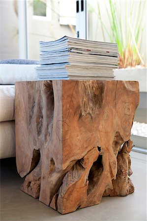 still life and elegant - Stack of magazines on a table made from tree stump Stock Photo - Premium Royalty-Free, Code: 6108-06904329