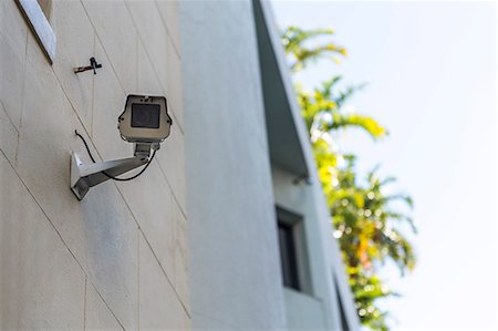 simsearch:6108-06904462,k - Low angle view of a CCTV camera mounted on a wall Stock Photo - Premium Royalty-Free, Code: 6108-06904440