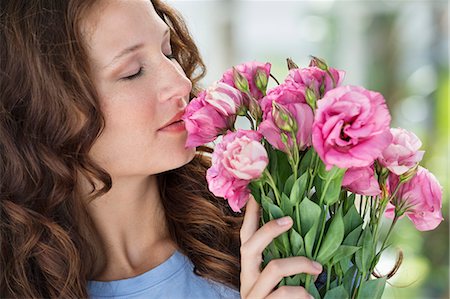 smelling - Close-up of a woman smelling flowers Stock Photo - Premium Royalty-Free, Code: 6108-06904791