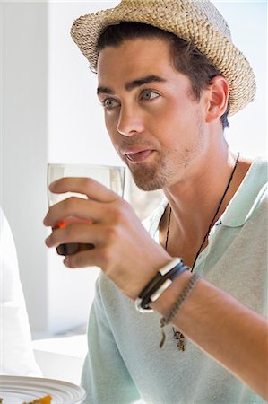 straw hat - Man drinking red wine at dining table Stock Photo - Premium Royalty-Free, Code: 6108-06904972