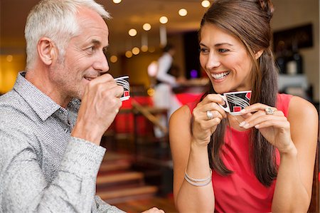 people looking at each other - Couple enjoying cup of tea in a restaurant Stock Photo - Premium Royalty-Free, Code: 6108-06904987