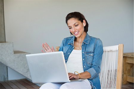 Woman doing online chatting on a laptop Stock Photo - Premium Royalty-Free, Code: 6108-06904903