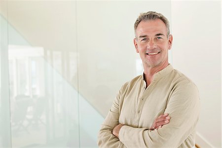 senior man happy portrait - Smiling man standing with his arms crossed Stock Photo - Premium Royalty-Free, Code: 6108-06905061