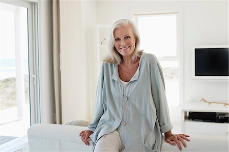 standing couch - Portrait of a woman smiling Stock Photo - Premium Royalty-Free, Code: 6108-06905068