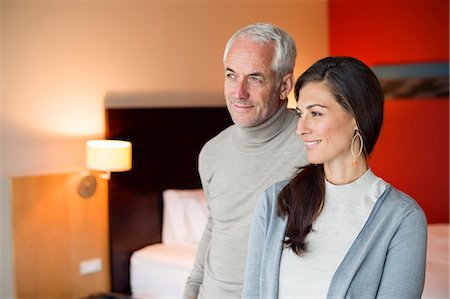 simsearch:6108-06905008,k - Couple smiling in a hotel room Stock Photo - Premium Royalty-Free, Code: 6108-06905032