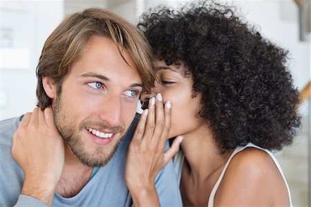 sharing secret - Woman whispering to a man Stock Photo - Premium Royalty-Free, Code: 6108-06905150