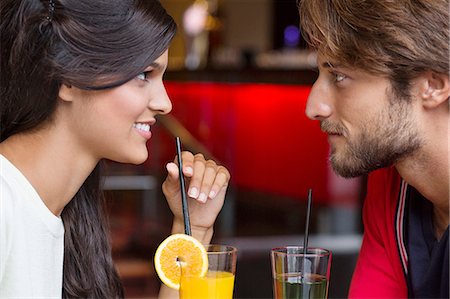 drinking straw not child - Couple drinking cocktail in a restaurant Stock Photo - Premium Royalty-Free, Code: 6108-06905170