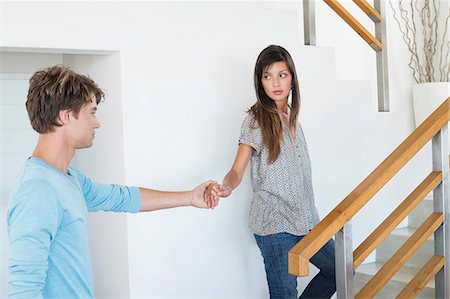 stairs casual - Romantic couple holding hands on a staircase Stock Photo - Premium Royalty-Free, Code: 6108-06905171