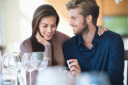 date - Man with engagement ring proposing his girlfriend in a restaurant Stock Photo - Premium Royalty-Free, Code: 6108-06905180