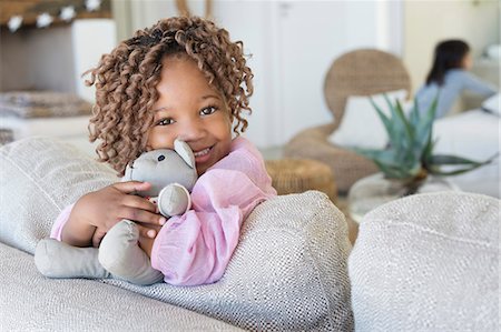 people africa two people - Portrait of a smiling girl holding a teddy bear Stock Photo - Premium Royalty-Free, Code: 6108-06905275