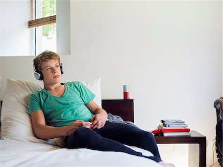simsearch:6108-08725387,k - Teenage boy listening to music on a mobile phone Stock Photo - Premium Royalty-Free, Code: 6108-06905217
