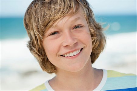 Portrait of a boy smiling on the beach Stock Photo - Premium Royalty-Free, Code: 6108-06905227