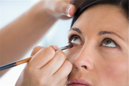 simsearch:6108-06906389,k - Woman applying mascara Stock Photo - Premium Royalty-Free, Code: 6108-06905373