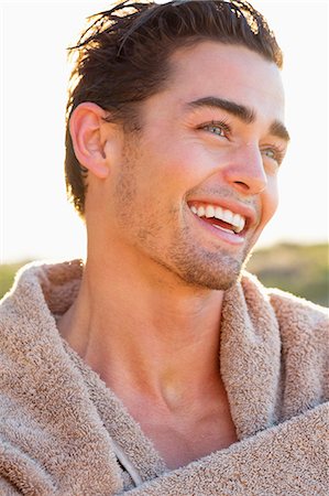 portrait sunshine happy - Man wrapped in a towel Stock Photo - Premium Royalty-Free, Code: 6108-06905396