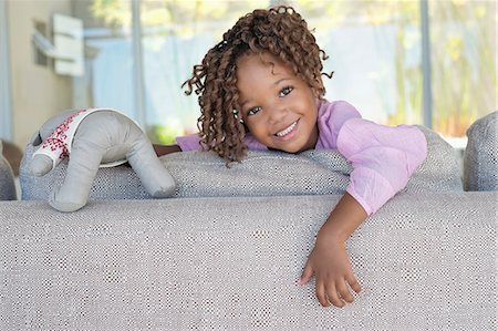 Portrait of a smiling girl holding a teddy bear Stock Photo - Premium Royalty-Free, Code: 6108-06905300