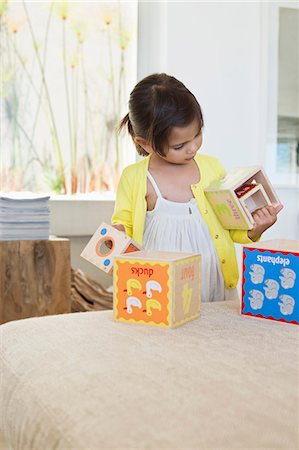 single kid playing - Girl playing with nested cubes Stock Photo - Premium Royalty-Free, Code: 6108-06905311