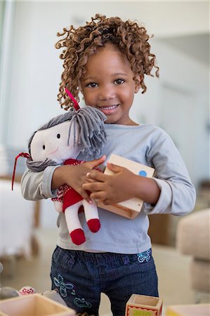 Portrait of a girl holding a rag doll Stock Photo - Premium Royalty-Free, Code: 6108-06905319