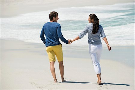 from behind - Couple enjoying on the beach Stock Photo - Premium Royalty-Free, Code: 6108-06905444