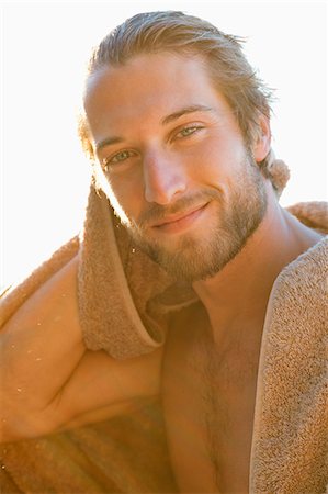 person with towel - Portrait of a man smiling Stock Photo - Premium Royalty-Free, Code: 6108-06905423