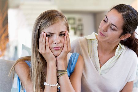 Woman persuading her upset daughter at home Photographie de stock - Premium Libres de Droits, Code: 6108-06905572