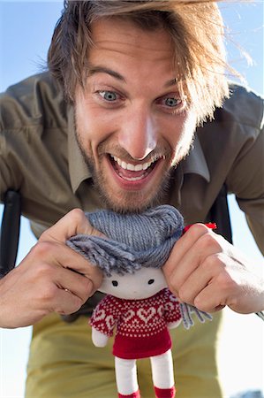 expressive faces adults - Man playing with a rag doll Stock Photo - Premium Royalty-Free, Code: 6108-06905591