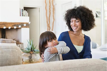 ethnic diversity - Woman smiling at her daughter Stock Photo - Premium Royalty-Free, Code: 6108-06905595