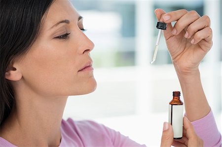 dropper - Close-up of a woman taking homeopathic medicine Stock Photo - Premium Royalty-Free, Code: 6108-06905666