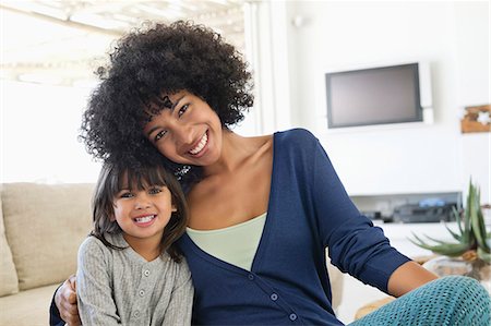 Portrait of a woman and her daughter smiling Stock Photo - Premium Royalty-Free, Code: 6108-06905616