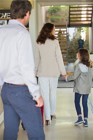 Man looking at his family leaving home Stock Photo - Premium Royalty-Free, Code: 6108-06905743