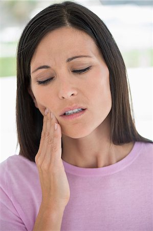 Woman suffering from a toothache Fotografie stock - Premium Royalty-Free, Codice: 6108-06905702