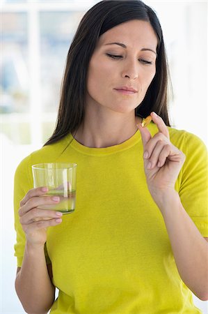 pictures of medicines tablet and capsule - Close-up of a woman taking medicine Stock Photo - Premium Royalty-Free, Code: 6108-06905716