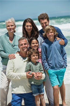 extended family senior grandchild - Portrait of a family smiling on the beach Stock Photo - Premium Royalty-Free, Code: 6108-06905900