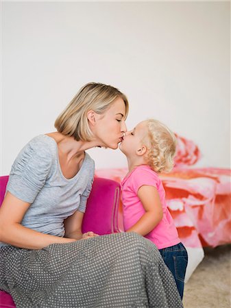 simsearch:6108-06906084,k - Mother and daughter kissing each other Stock Photo - Premium Royalty-Free, Code: 6108-06906058