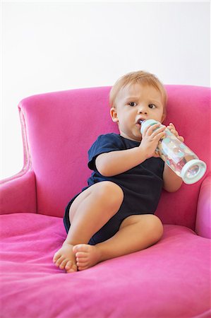 Baby boy drinking water from a bottle Stock Photo - Premium Royalty-Free, Code: 6108-06906088