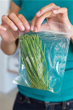 Woman packing leaf vegetables for storage Stock Photo - Premium Royalty-Free, Code: 6108-06906025