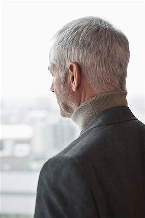 rear view photography - Man looking through a window Stock Photo - Premium Royalty-Free, Code: 6108-06906188