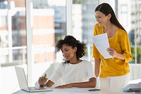 pictures of curly hair hispanics - Two female friends reviewing bill on a laptop at home Stock Photo - Premium Royalty-Free, Code: 6108-06906107