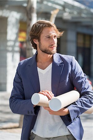 Architect carrying paper rolls Stock Photo - Premium Royalty-Free, Code: 6108-06906139