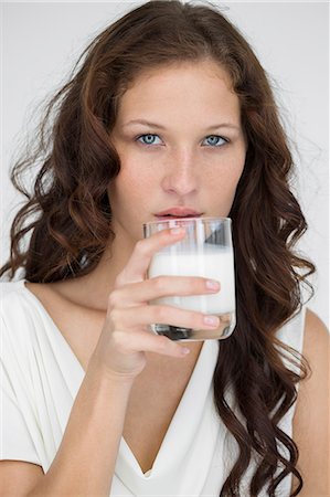 portrait long hair woman one person not blonde - Portrait of a woman drinking milk Stock Photo - Premium Royalty-Free, Code: 6108-06906369