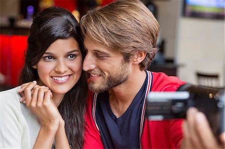 Couple filming themselves with a home video camera Stock Photo - Premium Royalty-Free, Code: 6108-06906332