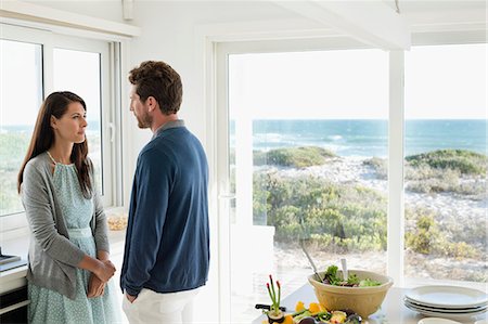 Couple talking to each other in the kitchen Stock Photo - Premium Royalty-Free, Code: 6108-06906407