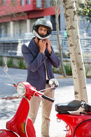 simsearch:6108-06906580,k - Man standing near a scooter on a street Stock Photo - Premium Royalty-Free, Code: 6108-06906549