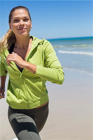 fitness and exercise with blonde woman - Portrait of a woman running on the beach Stock Photo - Premium Royalty-Free, Code: 6108-06906653