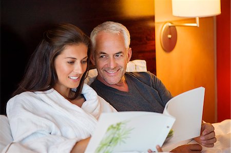 simsearch:6108-06907854,k - Couple reading a book in a hotel room Stock Photo - Premium Royalty-Free, Code: 6108-06906688