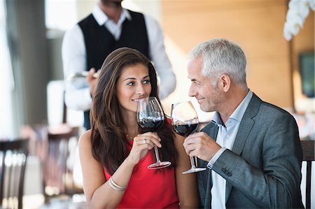 Couple enjoying red wine in a restaurant Stock Photo - Premium Royalty-Free, Code: 6108-06906727
